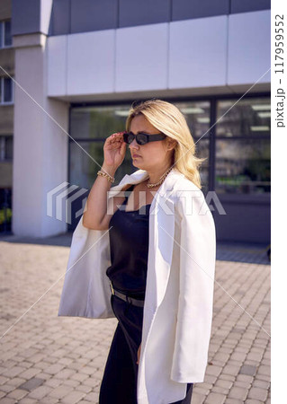 a       portrait of  middle-aged plus size woman in old money style clothes in a fancy restaurant 117959552