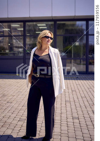 a       portrait of  middle-aged plus size woman in old money style clothes in a fancy restaurant 117959556