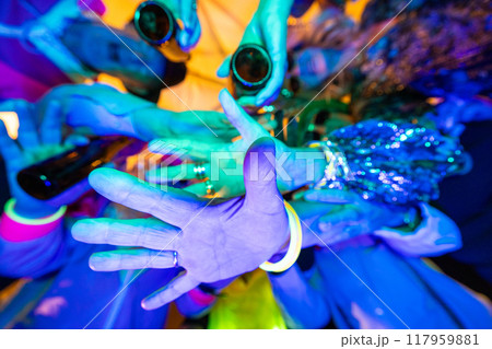 A dazzling and vibrant neon party scene filled with hands in dynamic motion and energy 117959881
