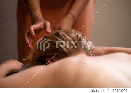 Head massage. Masseuse, client and scalp care, headache treatment and physiotherapy for healing Head massage. Masseuse, client and scalp care, headache treatment and physiotherapy for healing 117961001