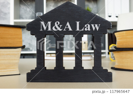 Mergers and acquisitions law sign on office desk. Corporate restructuring concept. 117965647