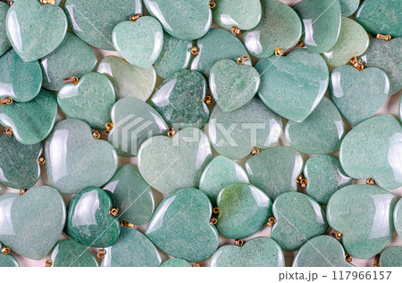 Scattered Green Aventurine Hearts in a Lush, Overlapping Pattern with Polished Surfaces, Ideal for Jewelry, Crafts, or Healing Practices. Scattered Green Aventurine Hearts in a Lush, Overlapping Pattern with Polished Surfaces, Ideal for Jewelry, Crafts, or Healing Practices. 117966157