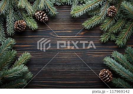 Christmas or New Year background with fir branches on the right and left side on dark wooden background. Place for your text. 117969142