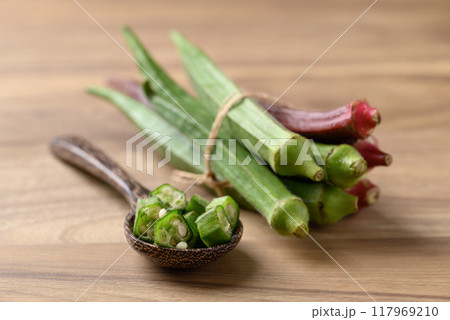 Fresh green and red okra on wooden background, Organic vegetable, Food ingredient Fresh green and red okra on wooden background, Organic vegetable, Food ingredient 117969210