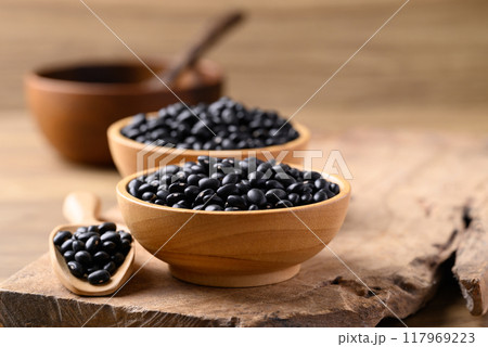 Black bean in bowl with spoon on wooden background, Food ingredient Black bean in bowl with spoon on wooden background, Food ingredient 117969223