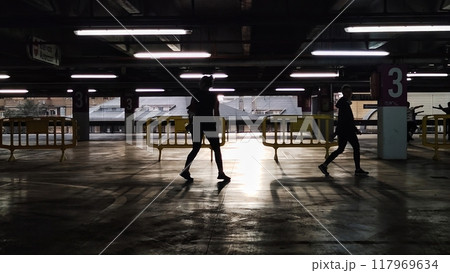 people walk through the closed parking. 117969634