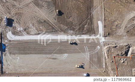 Earthmoving equipment. Aerial view of a large construction site with several earthmoving machines. Earthmoving equipment. Aerial view of a large construction site with several earthmoving machines. 117969662