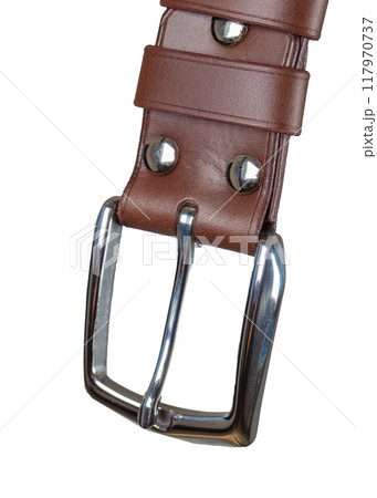 Part of a leather belt with a metal buckle close-up isolated on a white background. 117970737