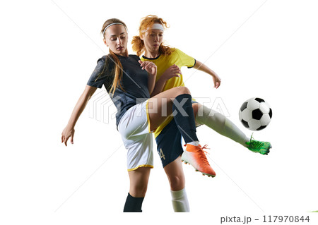 Athletic young women, mid-20s, soccer players, both battling for ball possession, with one player successfully blocking other on green field. Athletic young women, mid-20s, soccer players, both battling for ball possession, with one player successfully blocking other on green field. 117970844