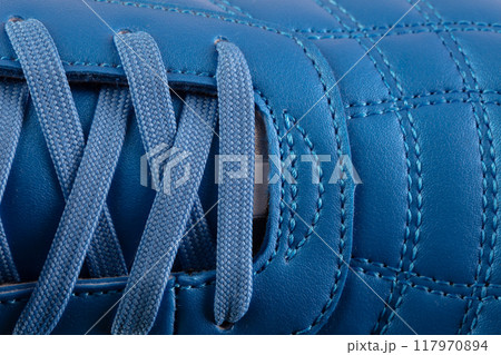 Part of a blue leather lace-up sneaker close-up. Shoe leather close-up. Part of a blue leather lace-up sneaker close-up. Shoe leather close-up. 117970894