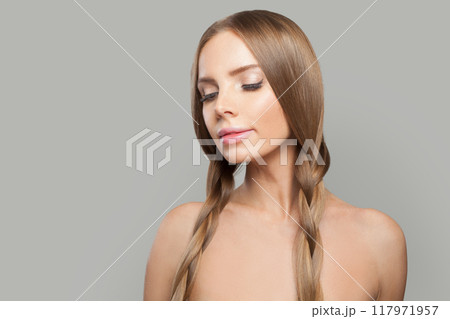 Cute young healthy woman with pigtail hairstyle and natural make-up on white background Cute young healthy woman with pigtail hairstyle and natural make-up on white background 117971957