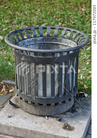 public trash can on city street filled with garbage. plastic waste in trash can container. 117972085