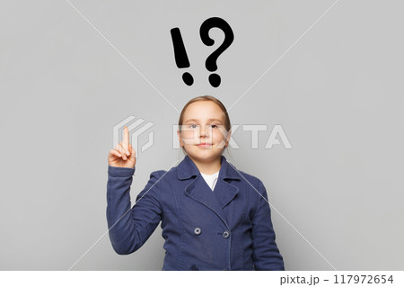 Successful young girl child school student with question mark pointing finger up. Successful young girl child school student with question mark pointing finger up. 117972654