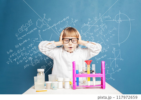Surprised young school student girl learning science. Research and education concept 117972659
