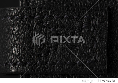 Black leather product closeup on a black background. 117973318