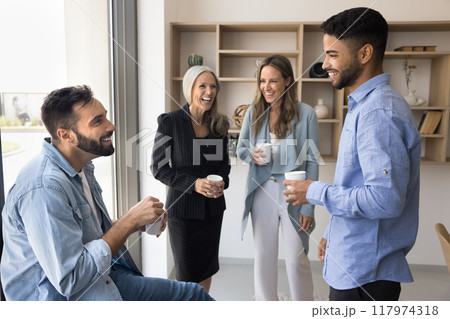 Cheerful diverse business colleagues talking and laughing 117974318