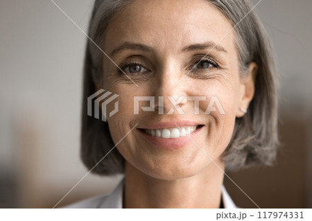 Portrait of happy middle-aged woman looking at camera 117974331