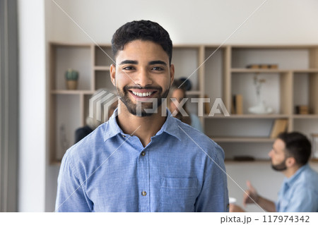 Cheerful young Arab business man posing for professional head shot 117974342