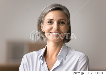 Portrait of beautiful smiling mature woman looking at camera 117974401