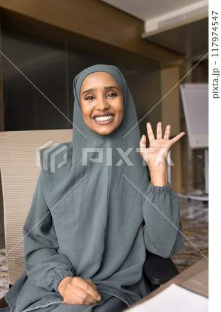 Positive young Arabic business professional woman speaking on Internet conference Positive young Arabic business professional woman speaking on Internet conference 117974547