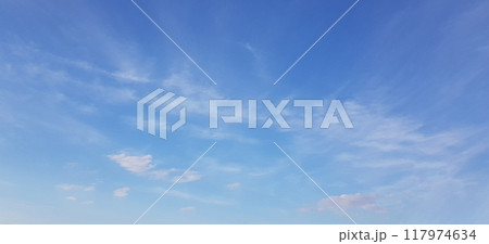 White clouds of different shapes in the blue sky, windy spring background 117974634