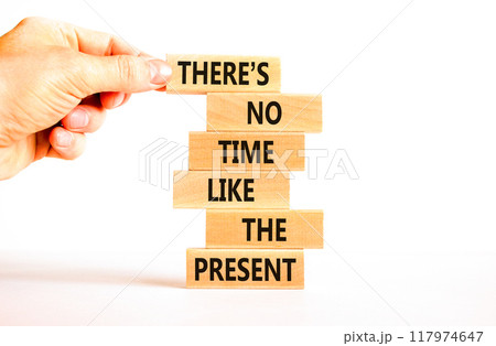 Present time symbol. Concept words There is no time like the present on wooden block. Beautiful white table white background. Businessman hand. Business Present time concept. Copy space. 117974647