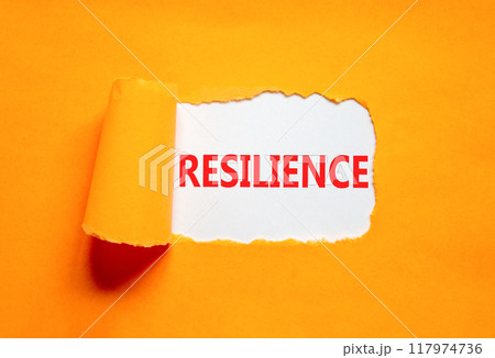 Resilience symbol. Concept word Resilience on beautiful white paper. Beautiful orange paper background. Business resilience concept. Copy space. Resilience symbol. Concept word Resilience on beautiful white paper. Beautiful orange paper background. Business resilience concept. Copy space. 117974736