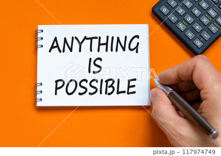 Anything is possible symbol. Concept words Anything is possible on beautiful white note. Beautiful orange background. Businessman hand. Calculator. Business anything possible concept. Copy space. 117974749