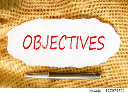 Objectives symbol. Concept word Objectives on beautiful white paper. Beautiful canvas background. Beautiful black pen. Business objectives concept. Copy space. 117974751
