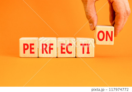 Perfection symbol. Concept word Perfection on beautiful wooden blocks. Beautiful orange background. Businessman hand. Business perfection concept. Copy space. Perfection symbol. Concept word Perfection on beautiful wooden blocks. Beautiful orange background. Businessman hand. Business perfection concept. Copy space. 117974772