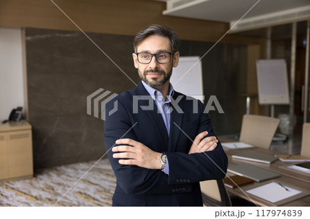 Confident pensive business leader man standing in office 117974839