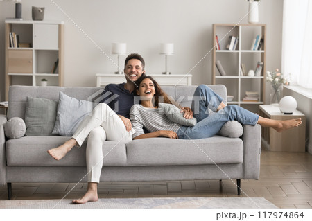 Happy couple enjoy leisure time at new apartment Happy couple enjoy leisure time at new apartment 117974864
