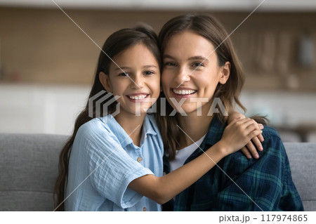 Cheerful beautiful mom and happy daughter child looking at camera Cheerful beautiful mom and happy daughter child looking at camera 117974865