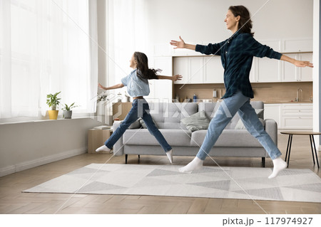 Pretty active kid girl and positive mom walking in air Pretty active kid girl and positive mom walking in air 117974927