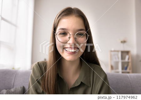 Smiling teen girl talk on video call looking at camera 117974962