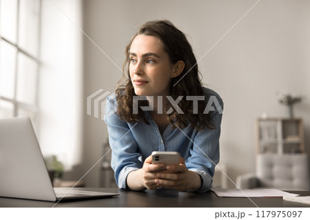 Woman using smartphone for browsing social media, chatting with friends 117975097
