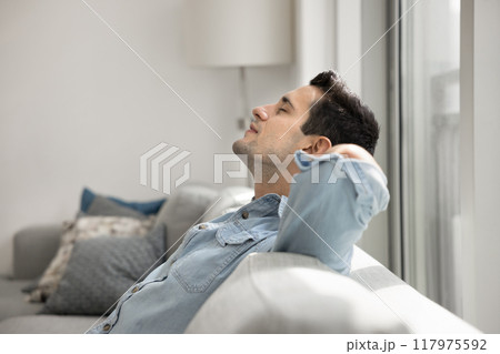 Happy peaceful young Hispanic man enjoying calm silent leisure time Happy peaceful young Hispanic man enjoying calm silent leisure time 117975592