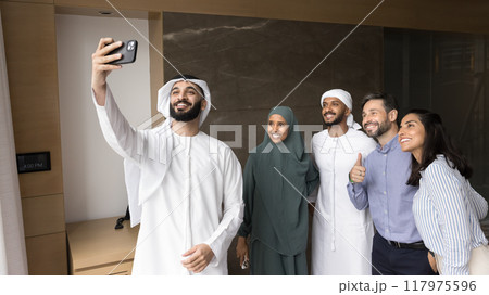 Happy young Arabian project leader taking selfie with business partners 117975596