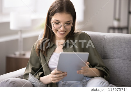 Happy teenager 16s girl browse internet use digital tablet device 117975714