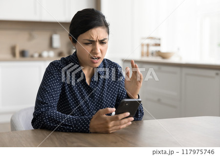 Upset young woman read bad news in message Upset young woman read bad news in message 117975746