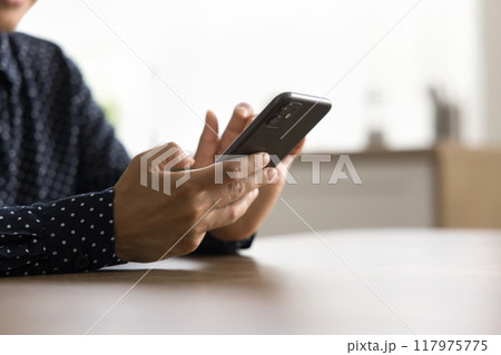Closeup female using smartphone for business calls or communication Closeup female using smartphone for business calls or communication 117975775