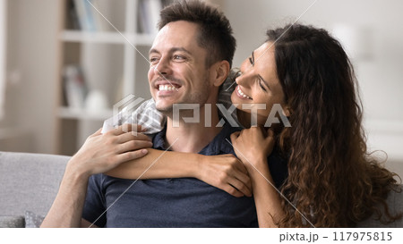 Smiling Latina woman hugging her beloved handsome husband 117975815