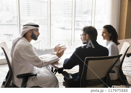 Successful young Arabian business owner man talking to European partners 117975888