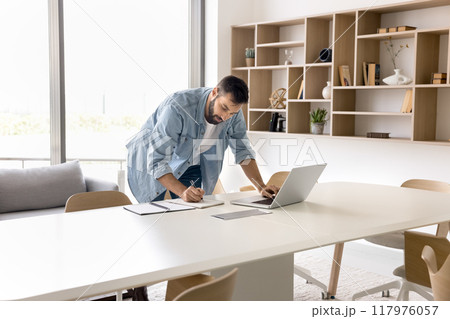 Focused entrepreneur man working in hurry, typing on laptop 117976057