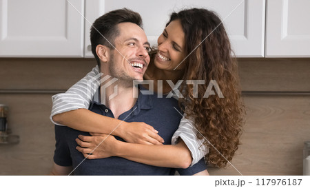 Loving Hispanic spouses spend time together in renovated modern kitchen Loving Hispanic spouses spend time together in renovated modern kitchen 117976187
