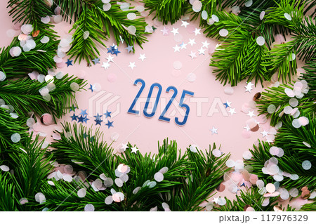 New Year 2025 pink background. Number of the coming year in Christmas decoration. New Year 2025 pink background. Number of the coming year in Christmas decoration. 117976329