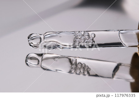 Pipette with cosmetic gel or serum close-up. 117976335