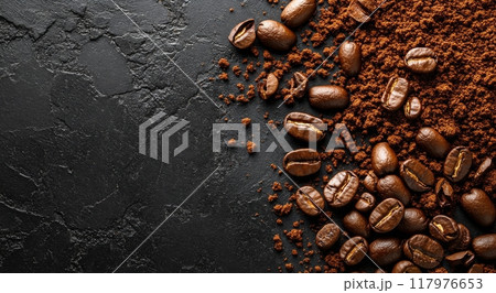 Freshly ground coffee beans on a dark surface ready for brewing morning coffee 117976653