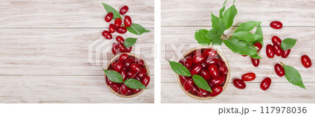 dogwood berry with leaf in bowl on white wooden background with copy space for your text. Top view 117978036