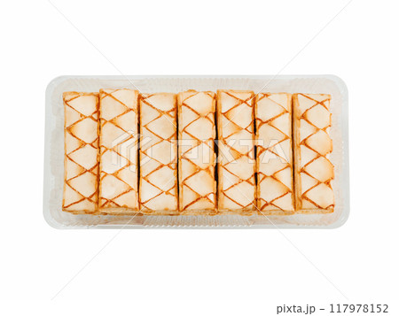 Italian crispy sweet bakery Sfogliatine glassate isolated on white background. Tasty cookies with apricot glaze puff pastries in container. Top view. Italian crispy sweet bakery Sfogliatine glassate isolated on white background. Tasty cookies with apricot glaze puff pastries in container. Top view. 117978152